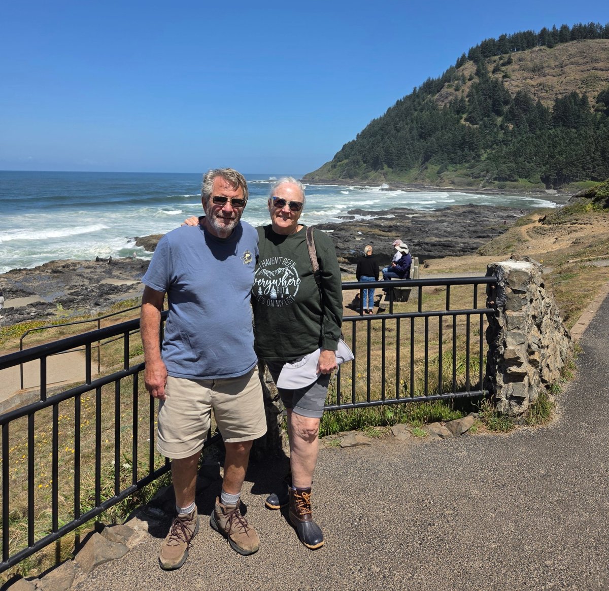 Sue McBride and a companion at an overlook on the rocky Oregon coast